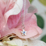 Forget me not flower necklace with a blue sapphire in sterling silver