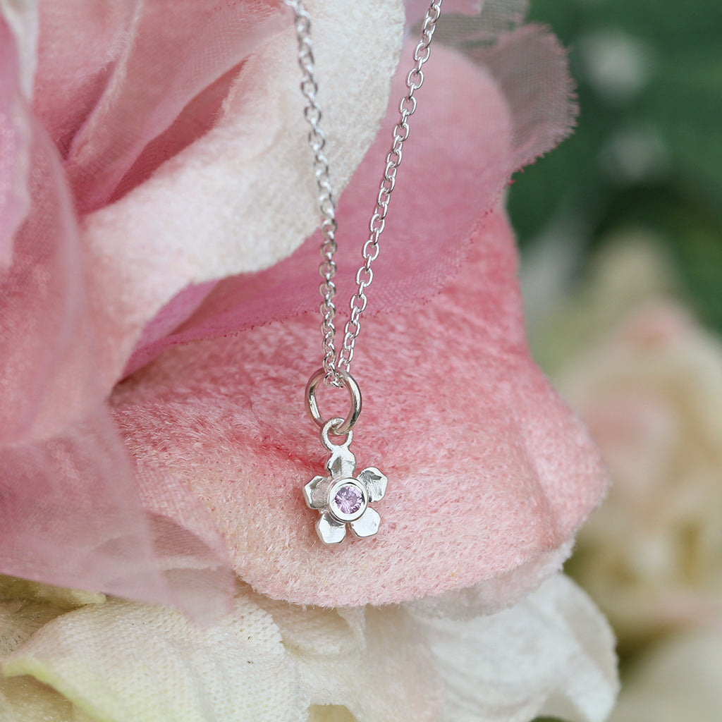 Forget me not flower necklace with a pink sapphire