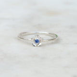 Silver forget me not flower ring with a blue sapphire