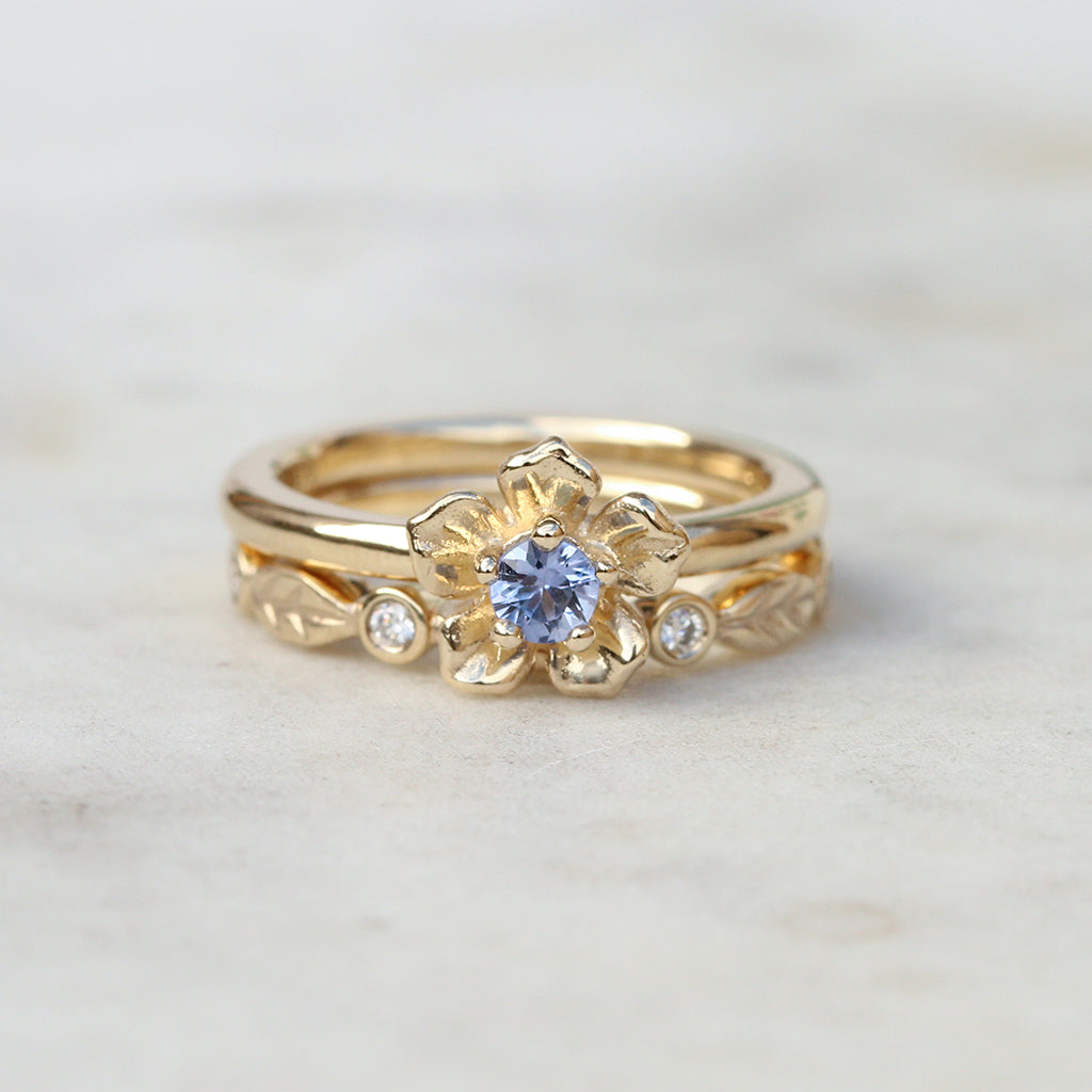 Sapphire forget me not ring with a diamond leaf band