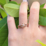 Forget me not flower engagement ring and leaf wedding ring in rose gold .
