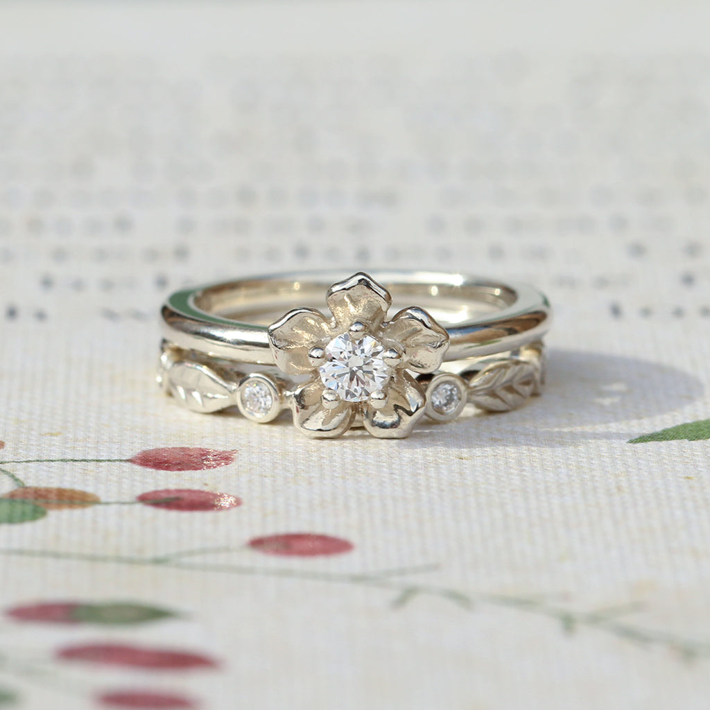 forget me not flower engagement ring and diamond leaf wedding band in white gold