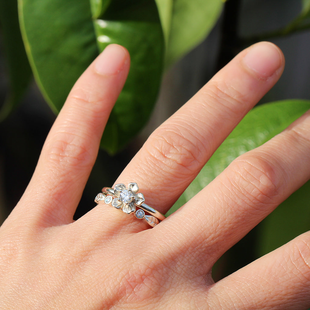 Forget me not flower engagement ring with a diamond leaf wedding band in white gold