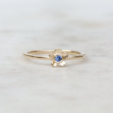 Gold forget me not flower ring with a blue sapphire