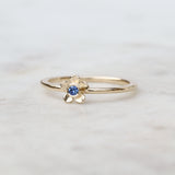 Gold forget me not flower ring with a Ceylon blue sapphire