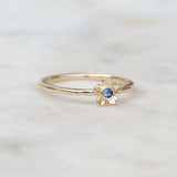 Gold forget me not flower ring with a blue sapphire