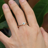 Gold forget me not flower ring with a blue sapphire