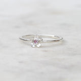 Silver forget me not flower ring with a pink sapphire