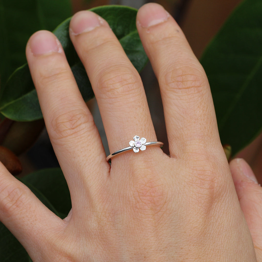Silver forget me not flower ring with a pink sapphire