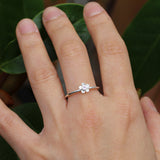 Silver forget me not flower ring with a pink sapphire