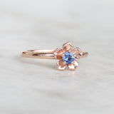 Rose gold forget me not flower ring with a Ceylon blue sapphire