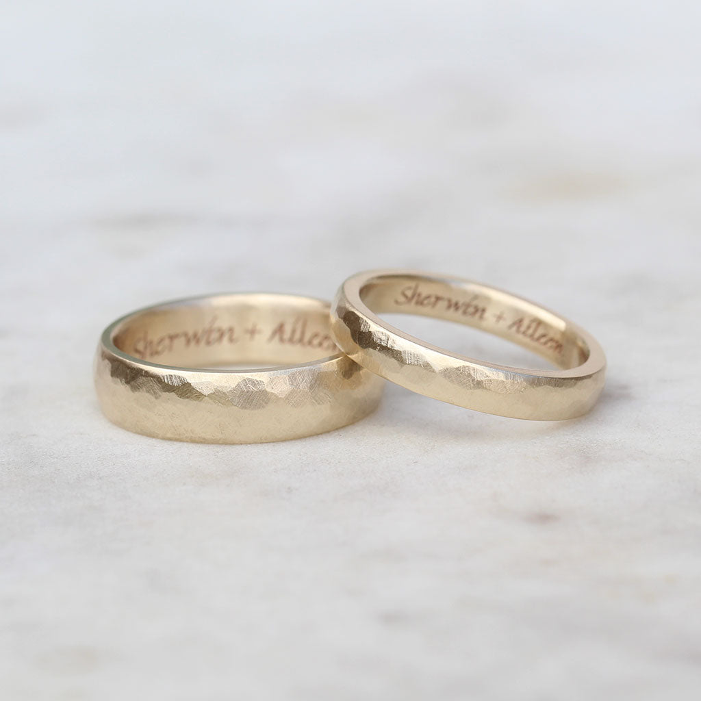 Gold hammered wedding rings engraved