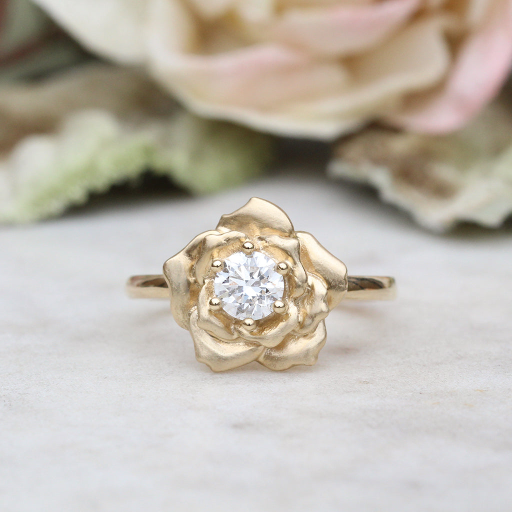 Gold rose ring with a diamond