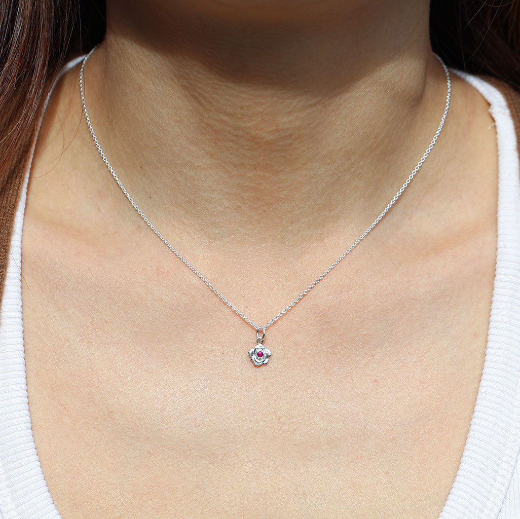 Petite rose pendant with a ruby