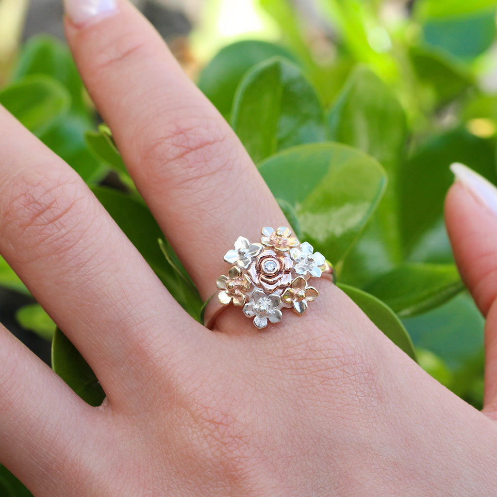 Hand wearing a flower bouquet ring