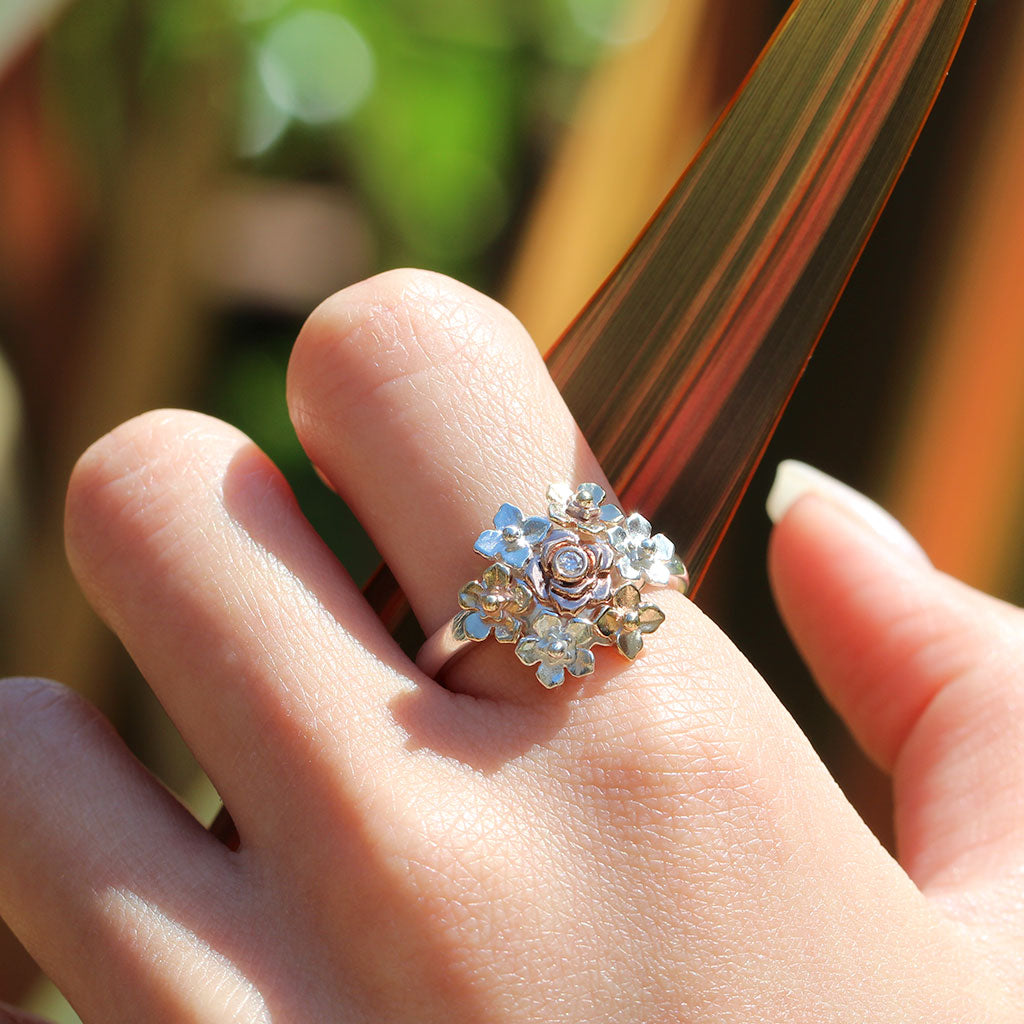 Hand wearing a posy ring with a diamond