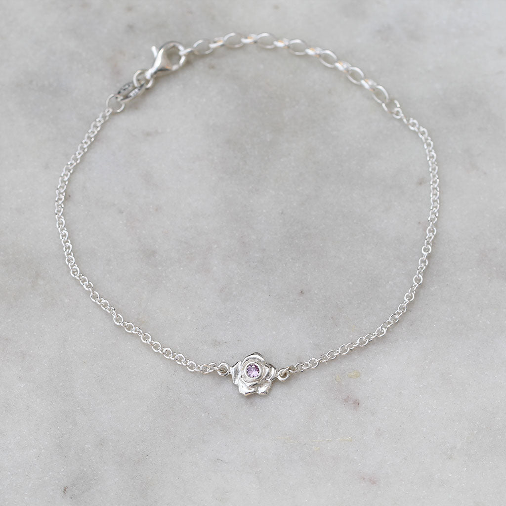 silver rose bracelet with a pink sapphire