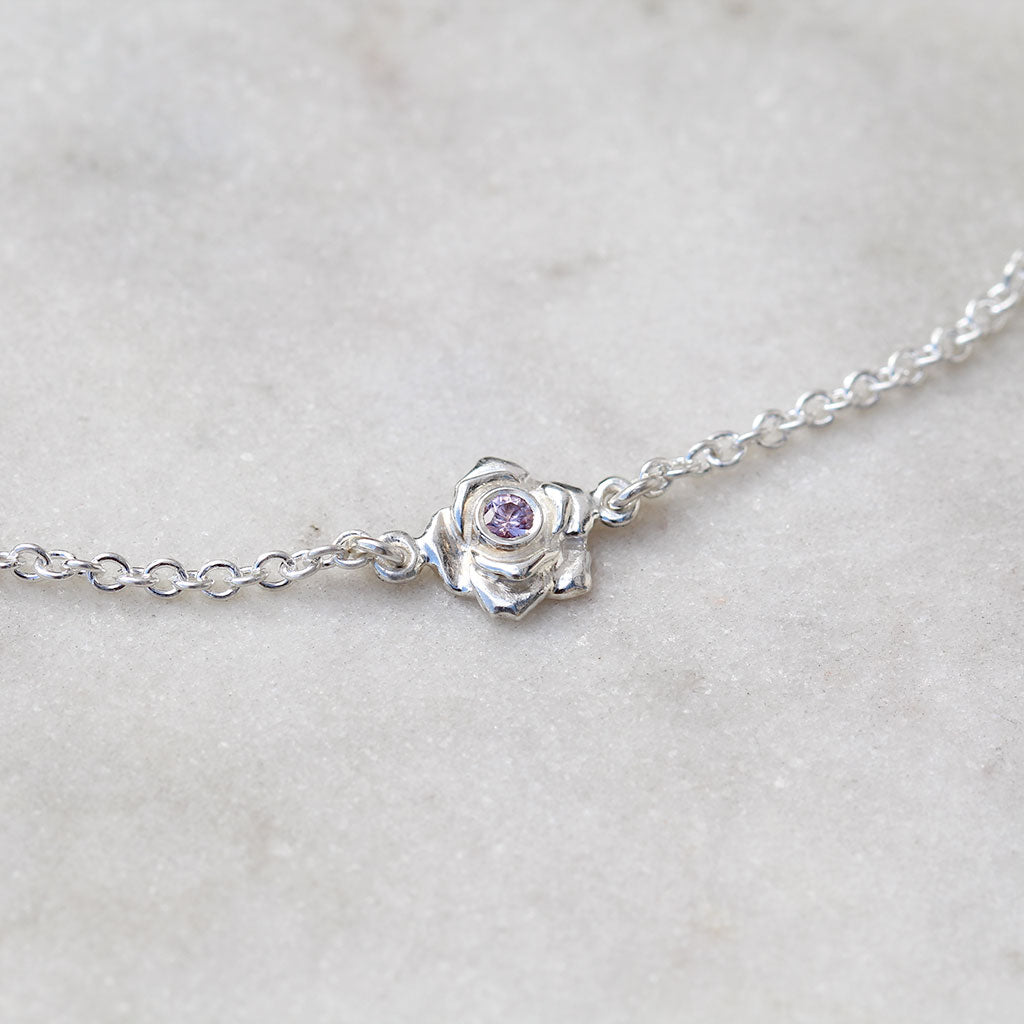 Sterling silver rose bracelet with a pink sapphire