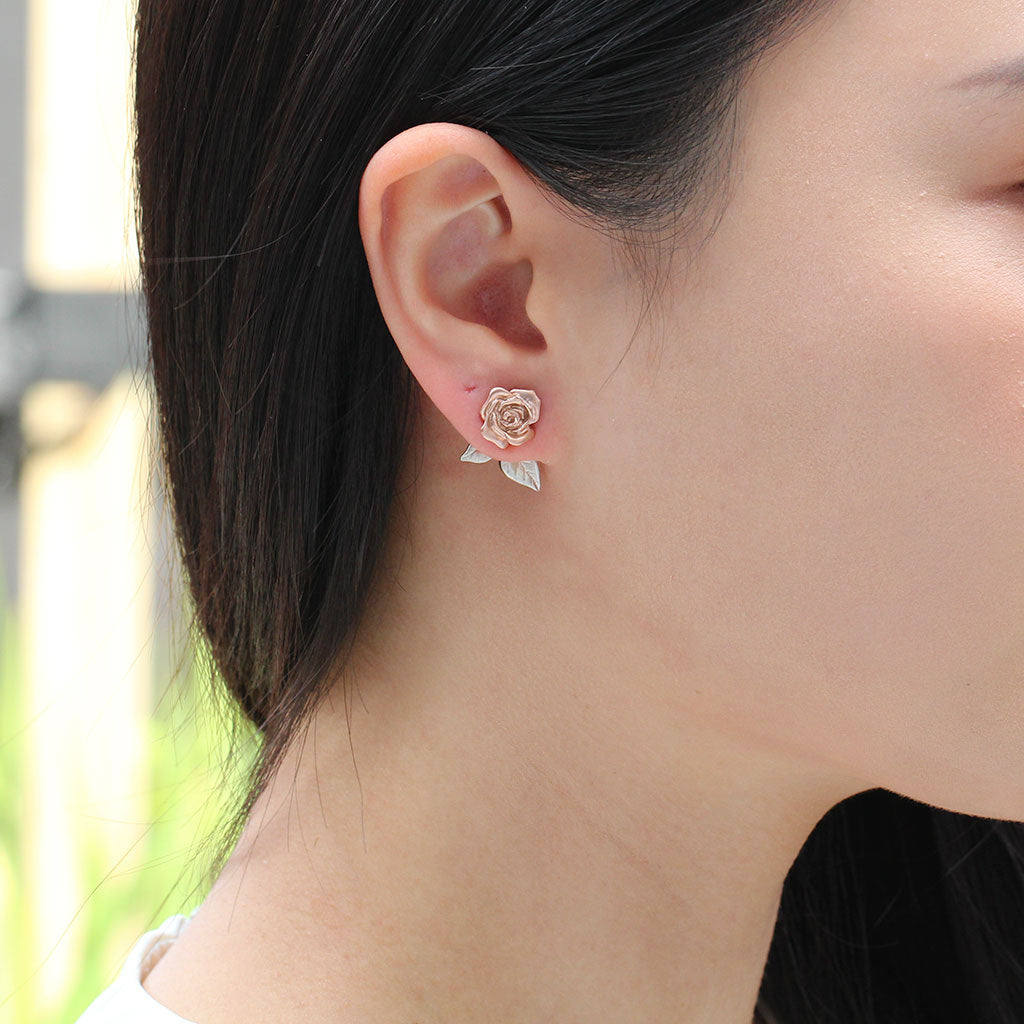 Rose earrings in rose gold with leaf ear jackets