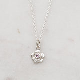 Silver rose necklace with a pink sapphire