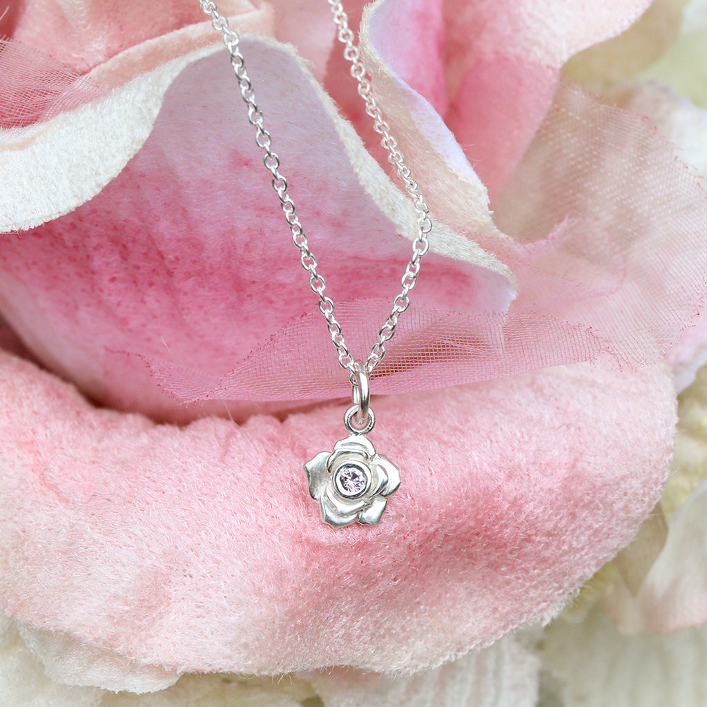 Silver rose necklace with a pink sapphire