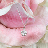 Silver rose necklace with a pink sapphire
