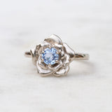White gold rose engagement ring with a Ceylon sapphire
