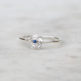 Silver rose ring with a blue sapphire