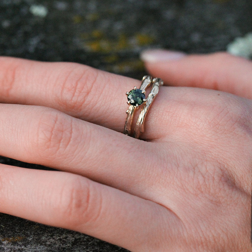 Twig green sapphire engagement ring with a twig wedding ring in gold