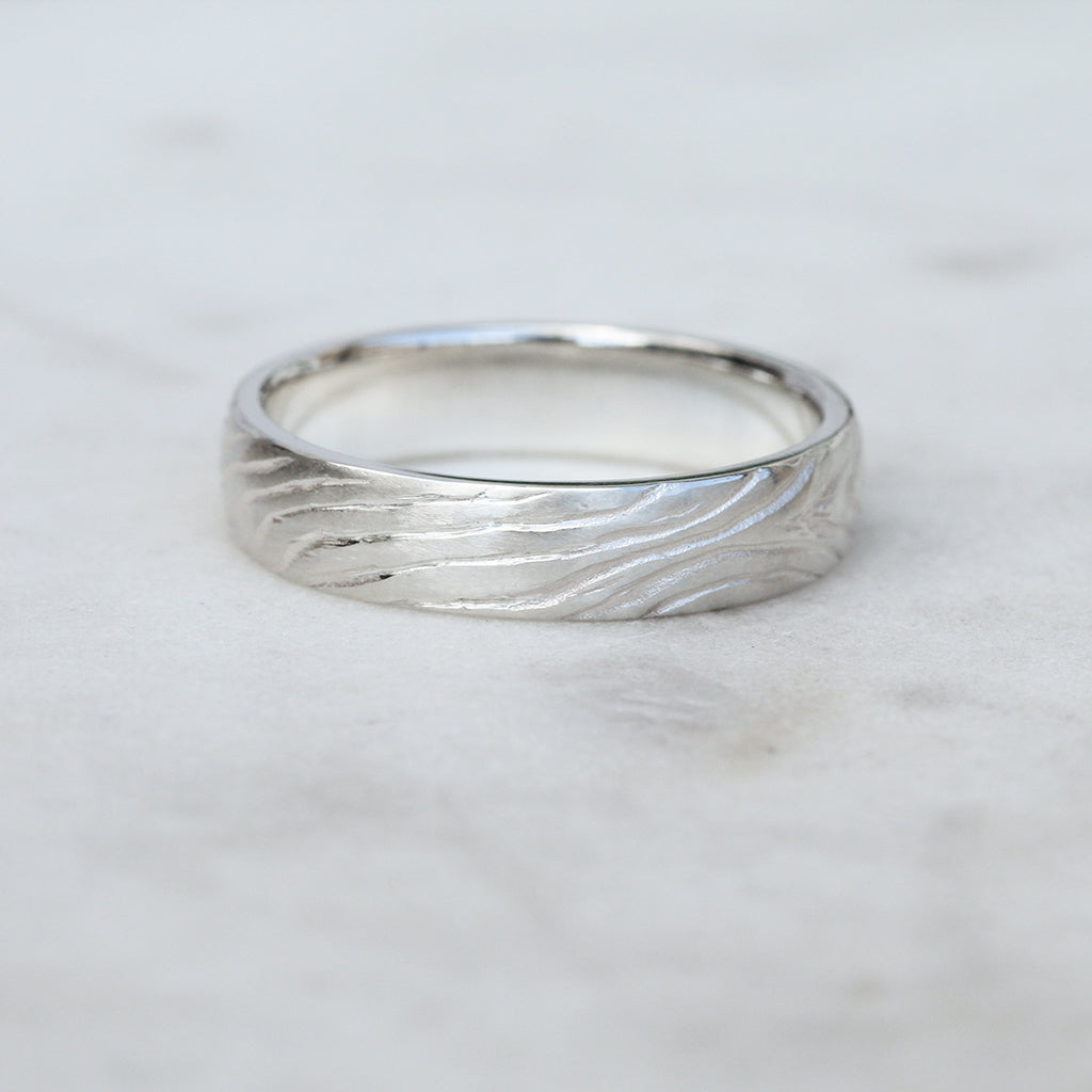 Men's wedding band with tree ring pattern texture