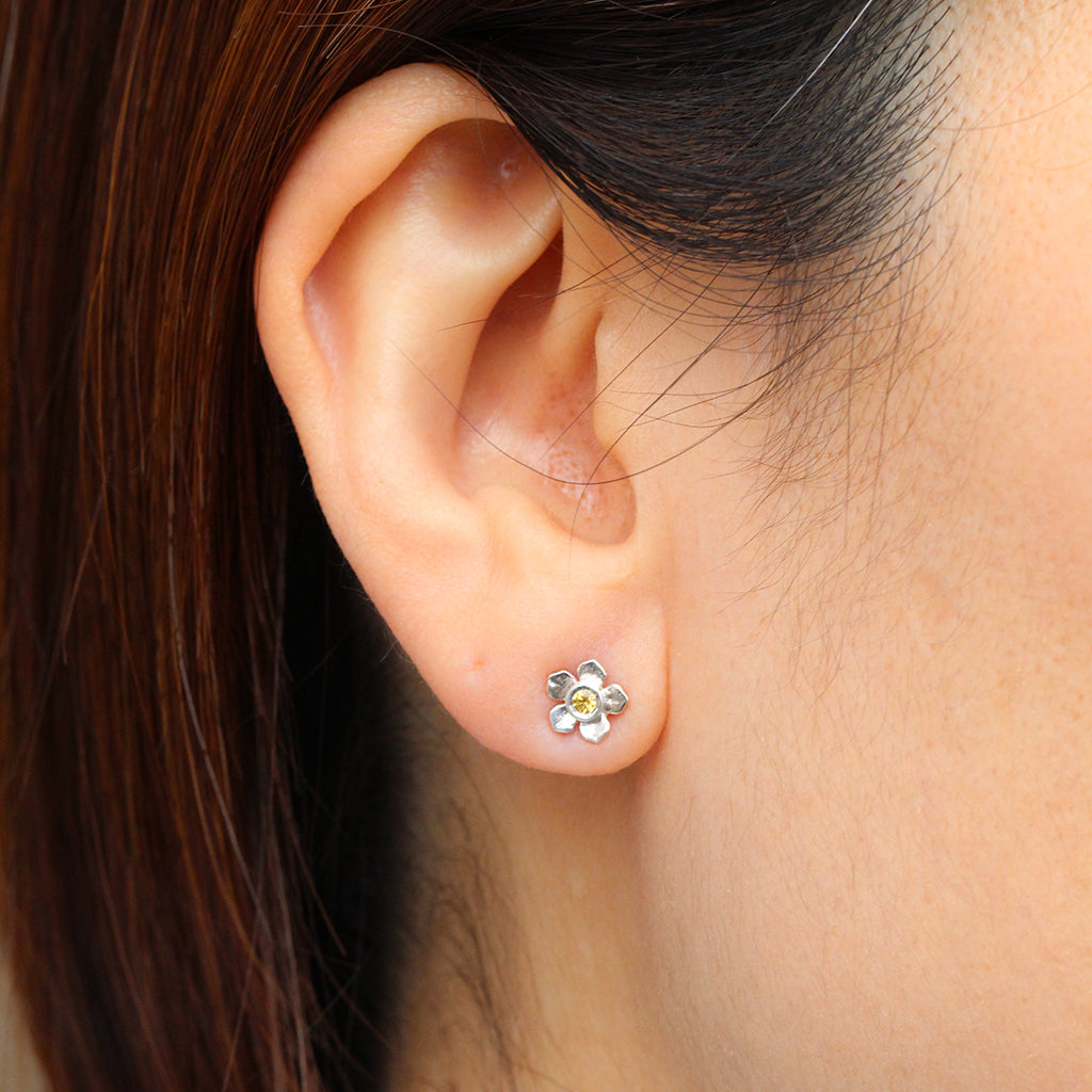 Silver forget me not flower stud with a yellow sapphire