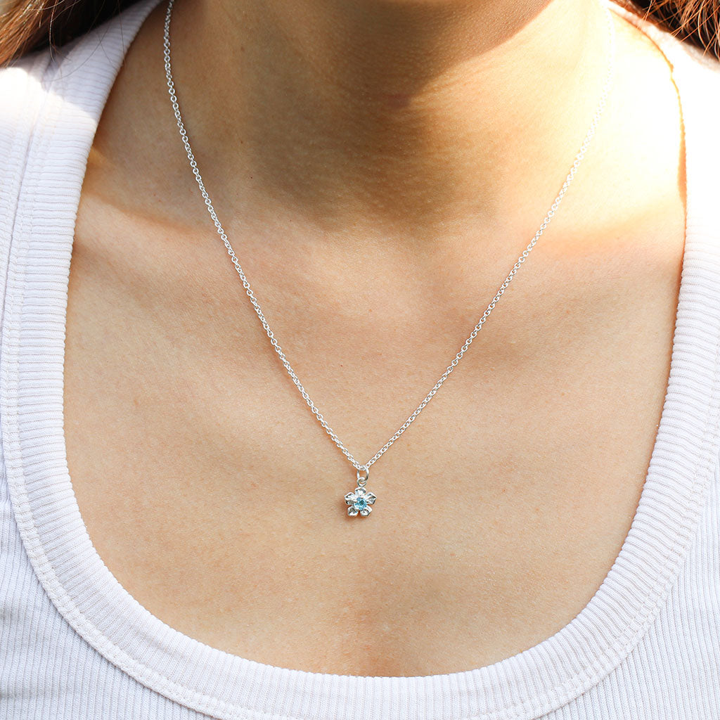 Forget me not flower necklace in silver with a blue topaz