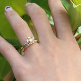 Gold forget me not flower engagement ring with a leaf diamond wedding ring