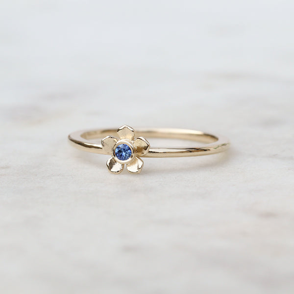 Gold forget me not flower ring with a Ceylon blue sapphire