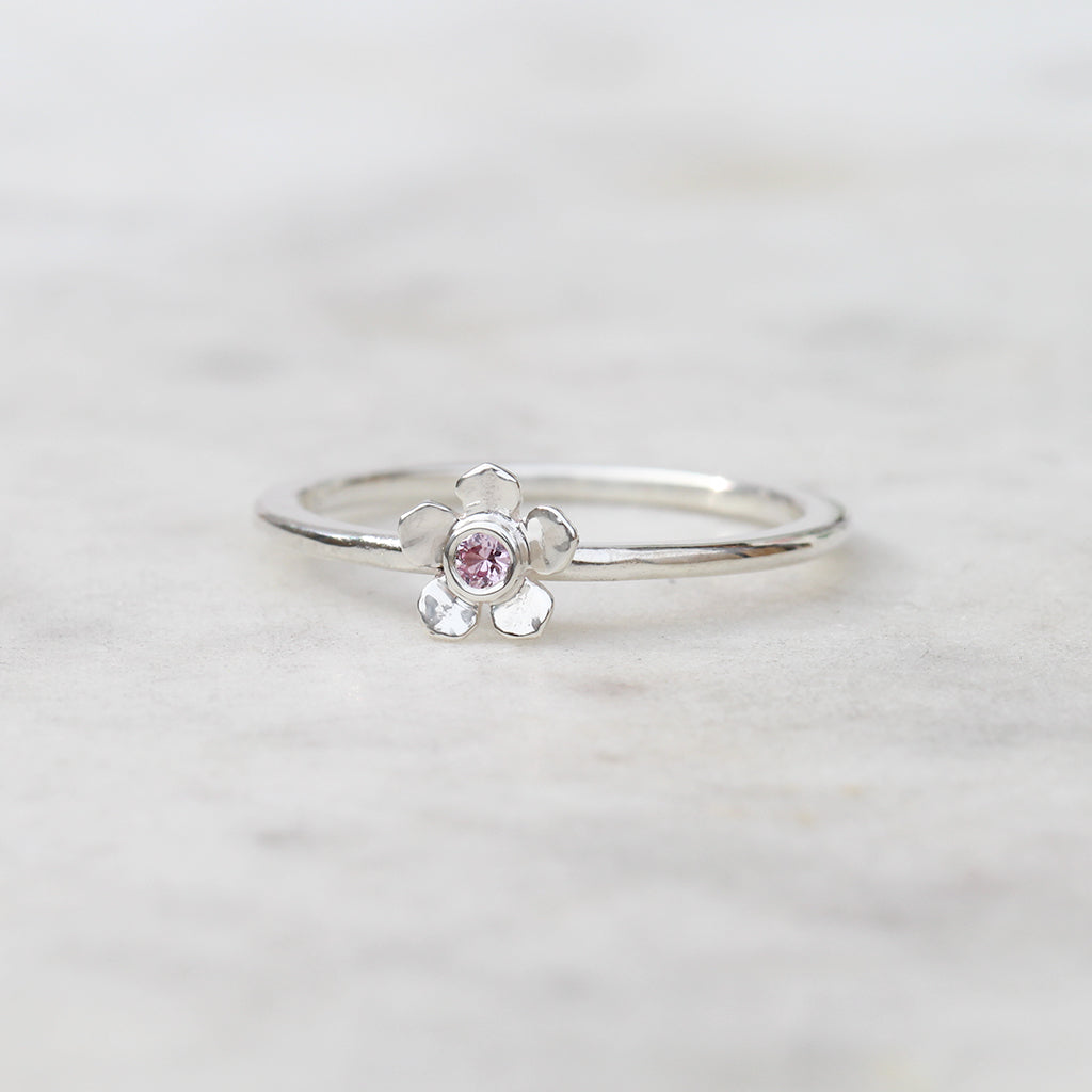 Silver forget me not flower ring with a pink sapphire
