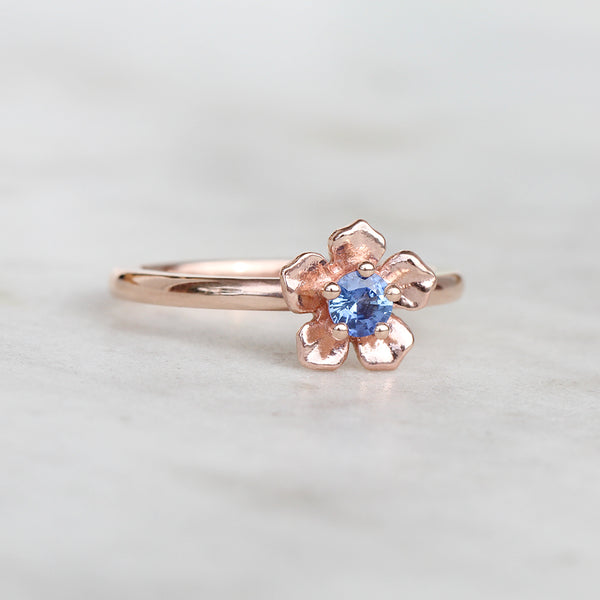 Rose gold forget me not flower ring with a Ceylon blue sapphire