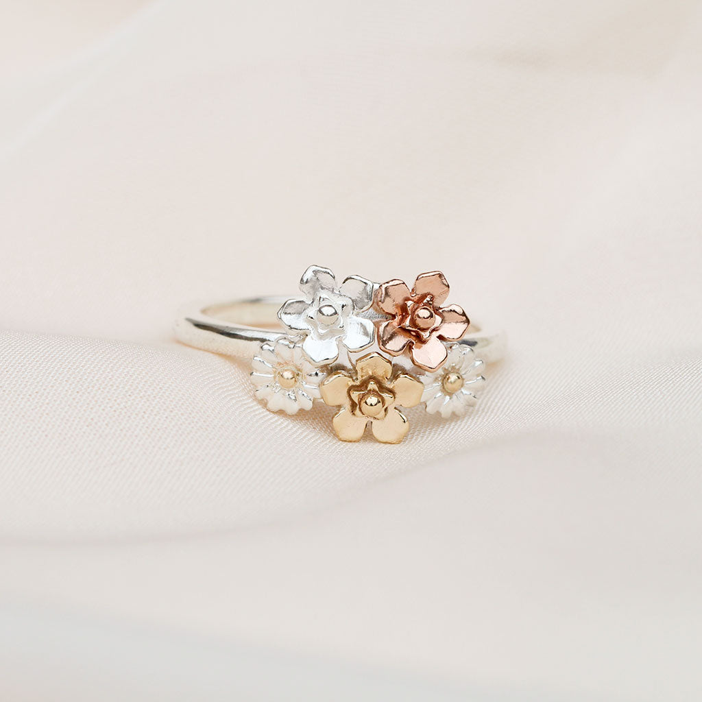 Floral ring with silver, rose gold, and yellow gold