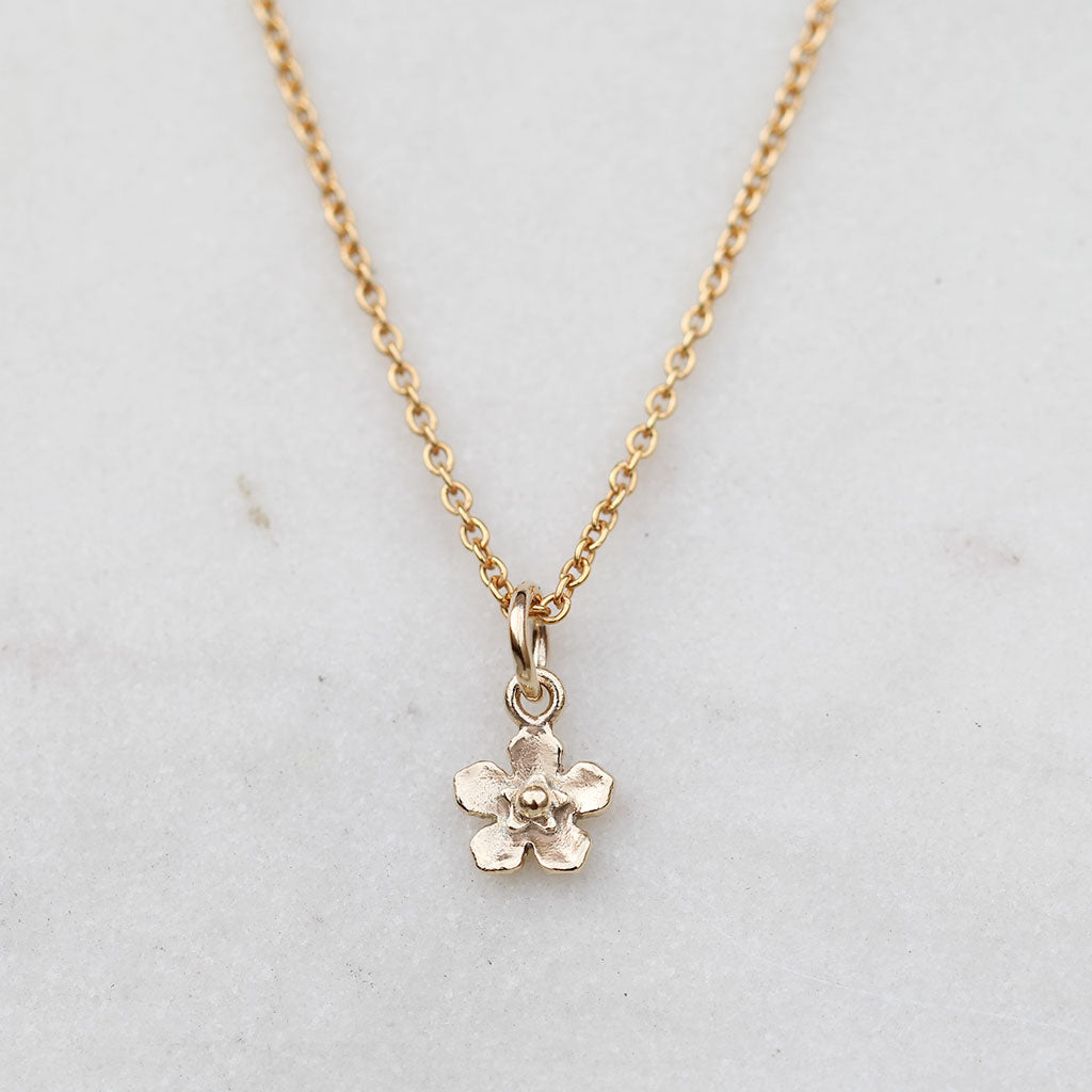 Petite gold forget me not flower necklace