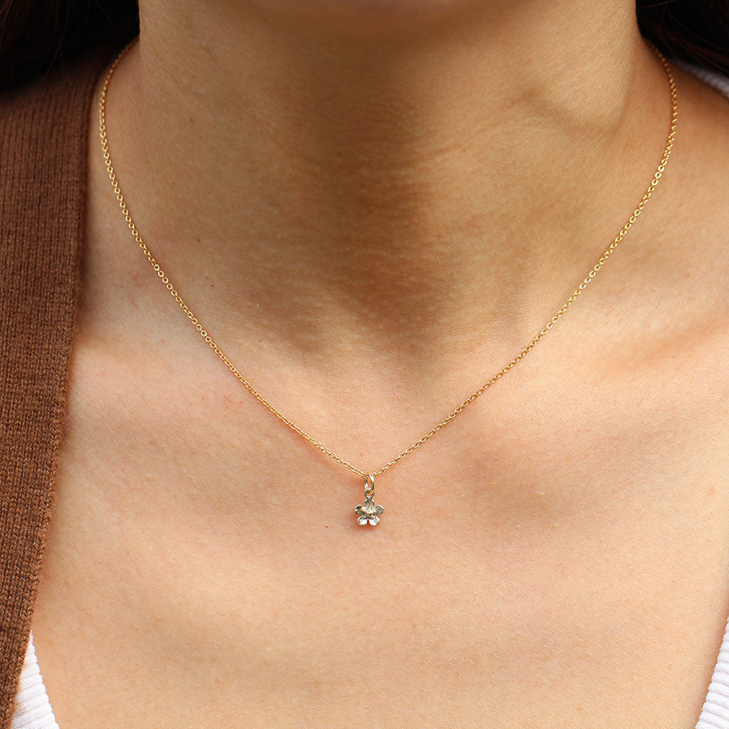 Gold mini forget me not flower necklace