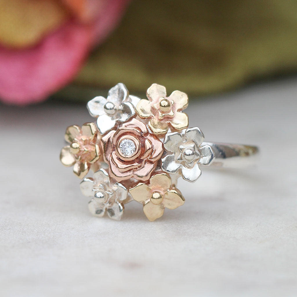 Rose gold, yellow gold and silver floral ring with a diamond