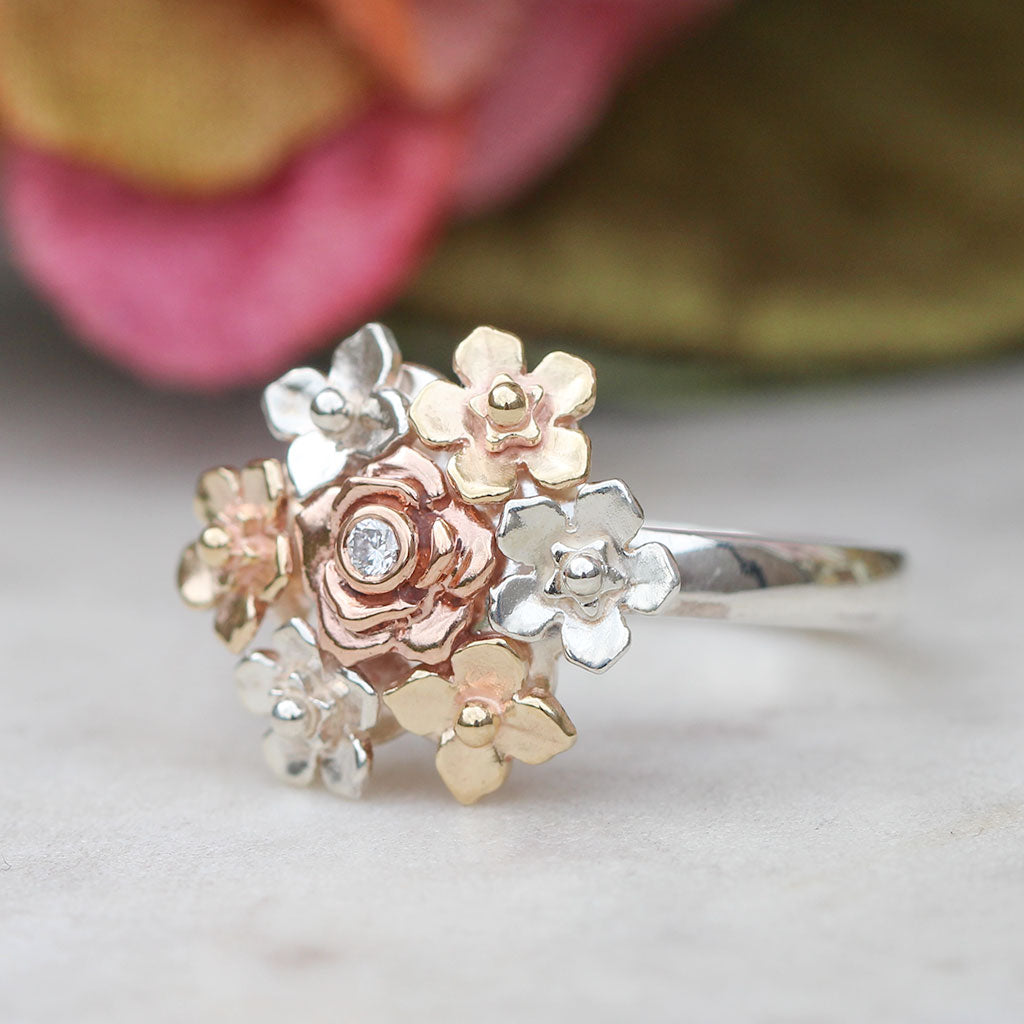 Silver ring with rose gold and white gold floral designs