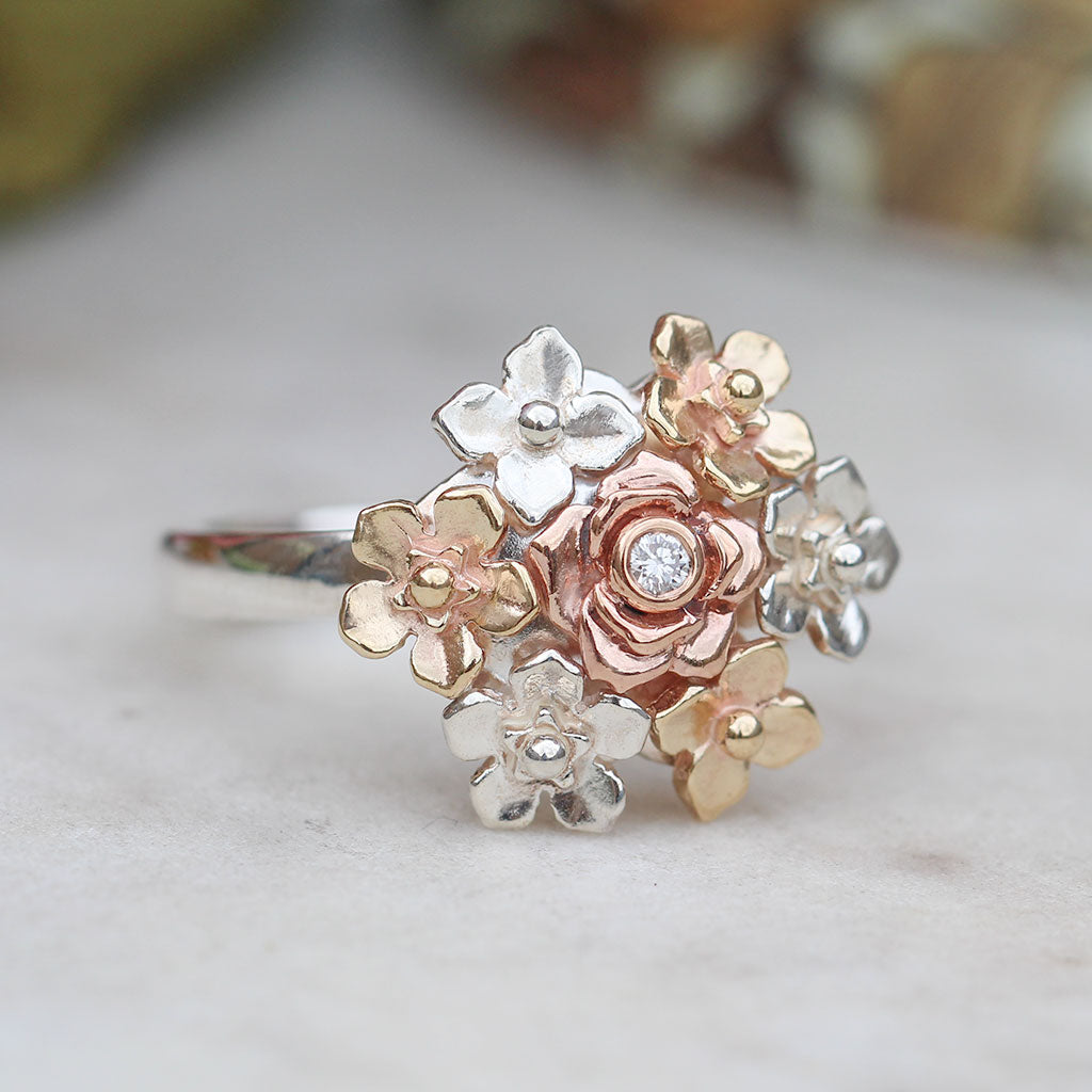 Floral ring with silver, yellow gold and rose gold flowers