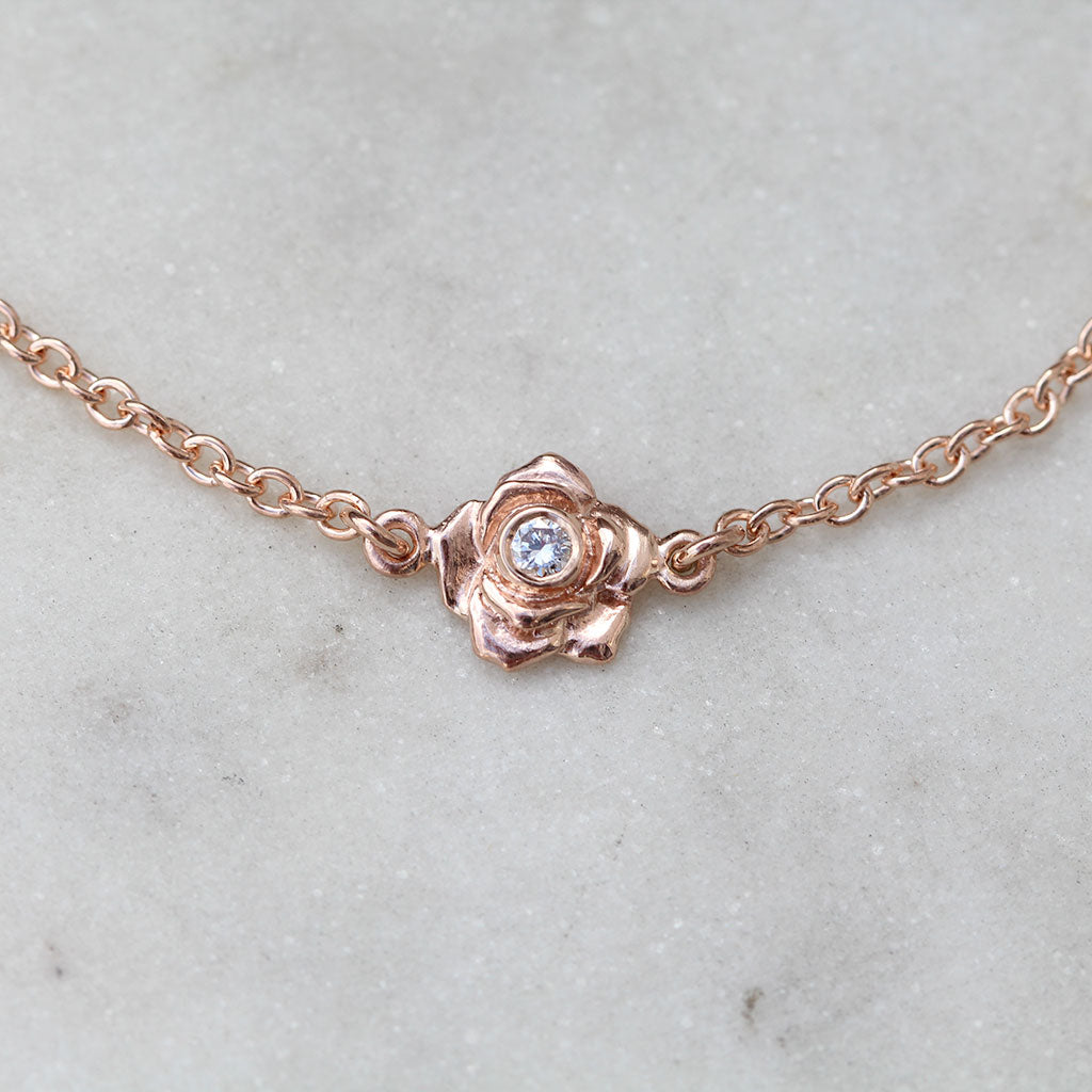 Rose gold rose bracelet with a diamond