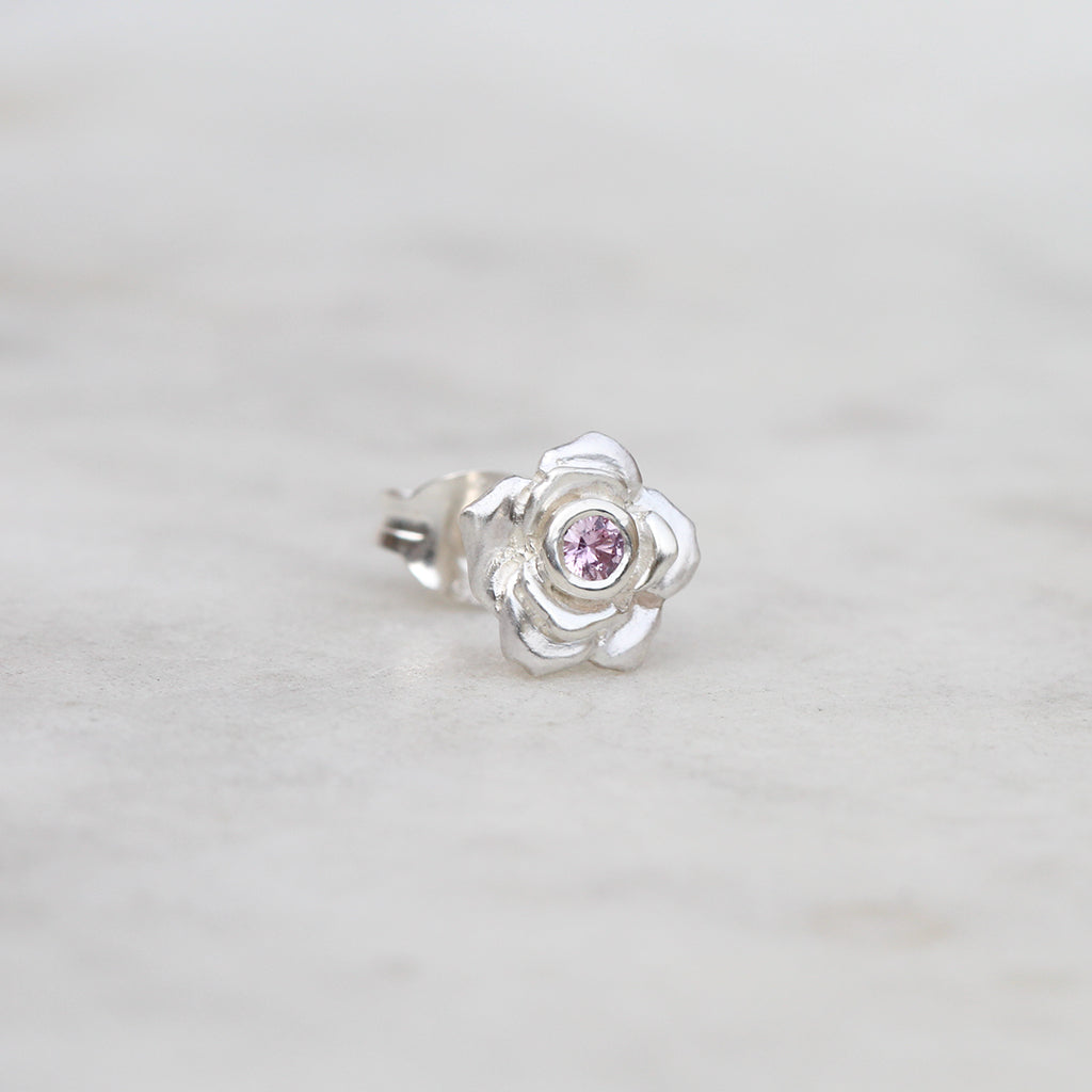 Silver rose stud with a pink sapphire