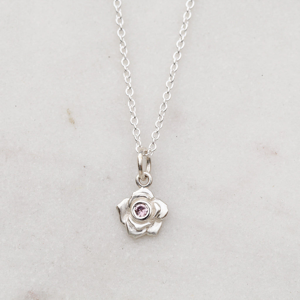 Silver rose necklace with a pink sapphire