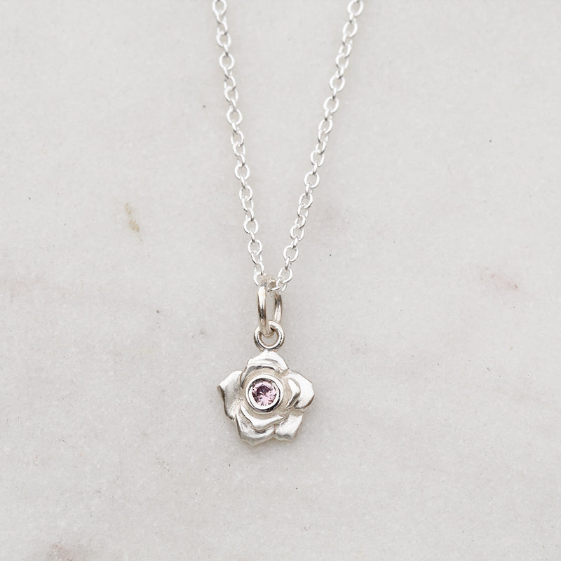 Silver rose necklace with a pink sapphire