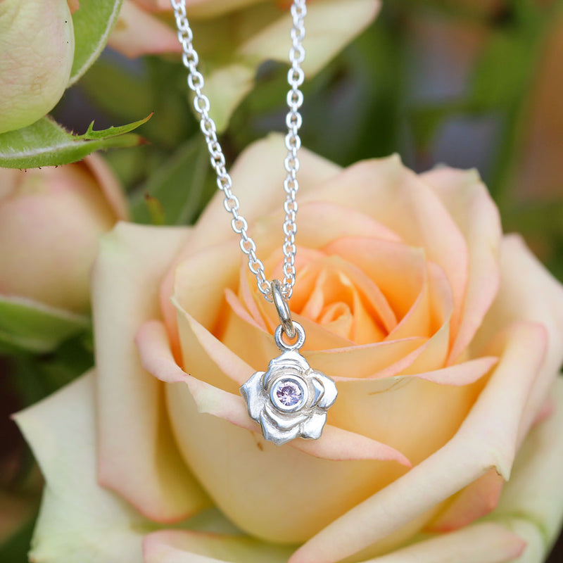 Silver rose necklace with a pink sapphire