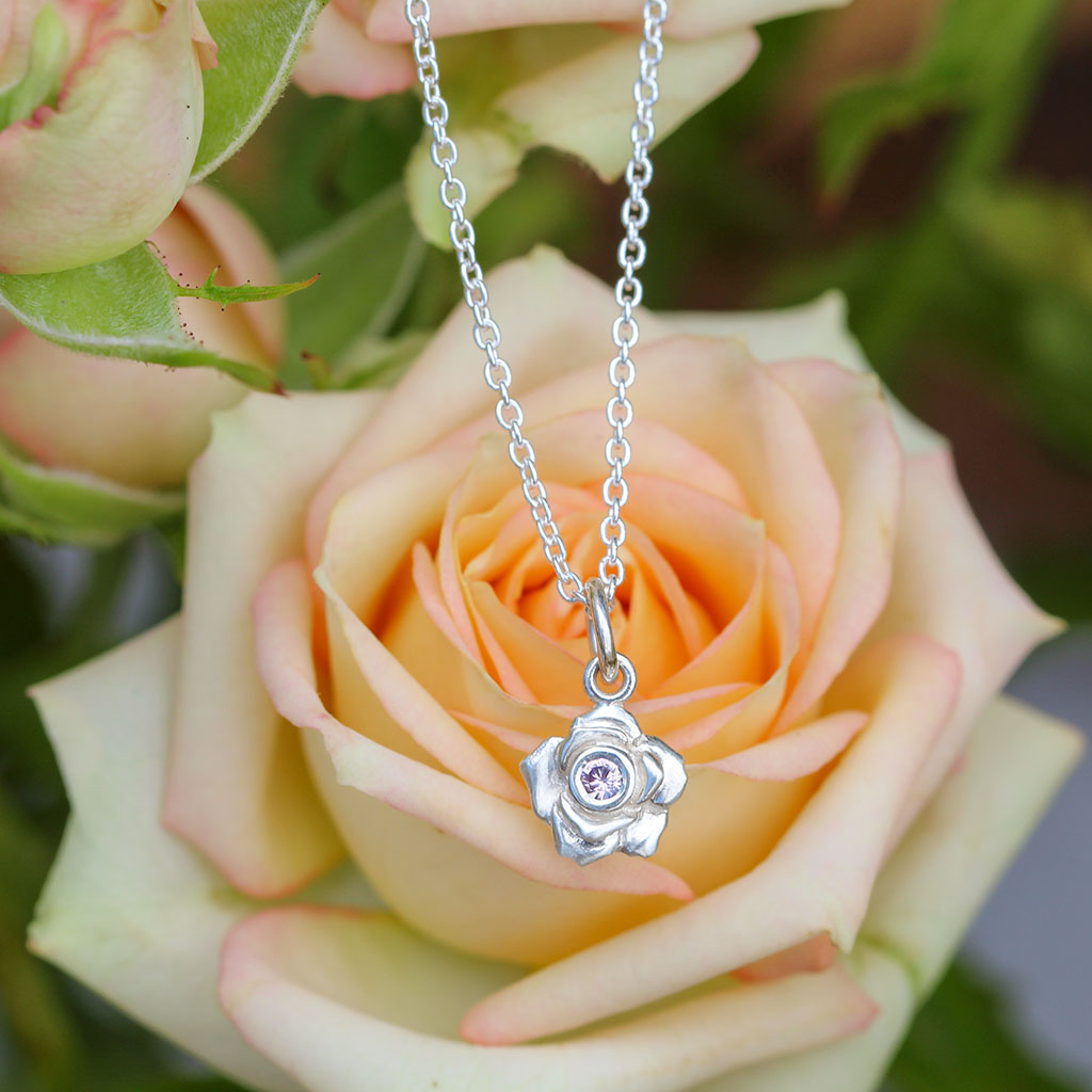 Sterling silver rose pendant with a pink sapphire