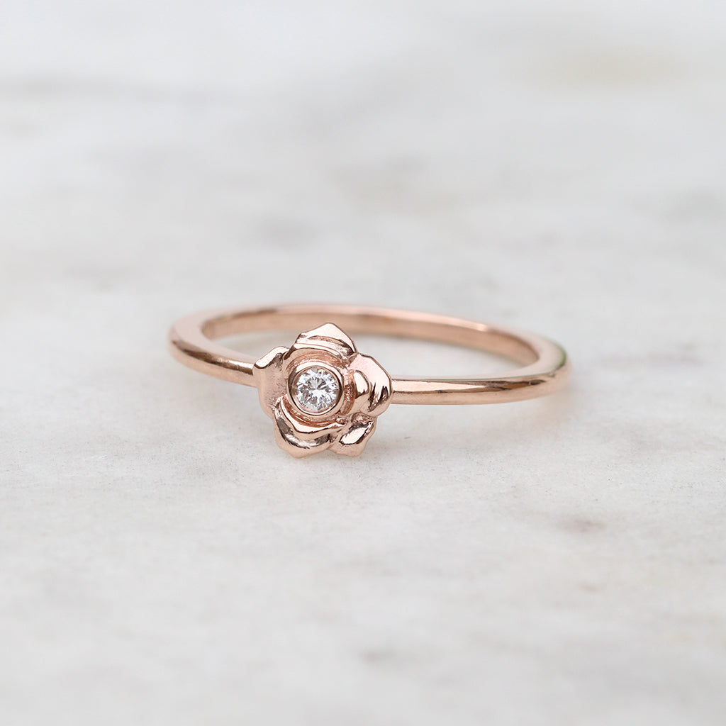 Rose gold rose ring with a diamond