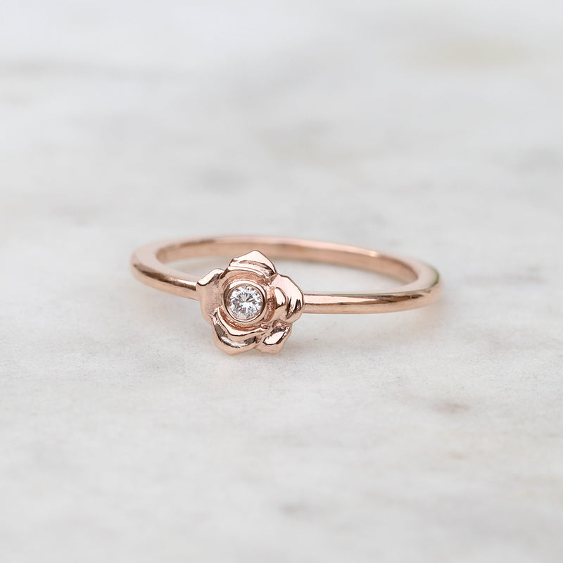 Rose gold rose ring with a diamond